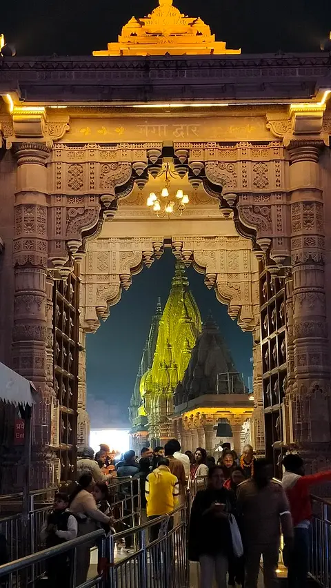 The gilded gateway of the Kashi Vishwanath temple, lit at night
