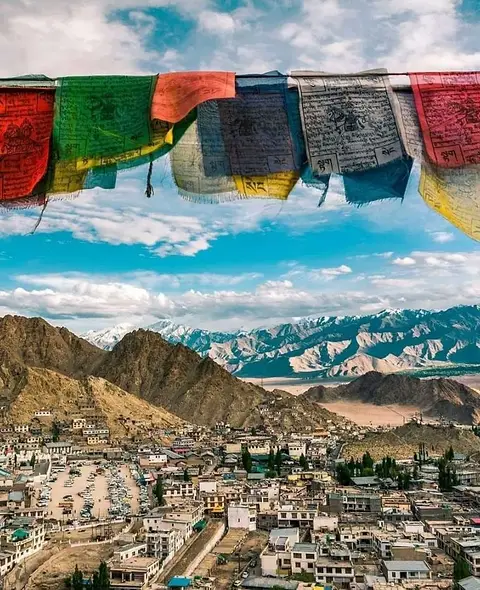 Prayer flags strung above Leh, the town spread out below against the mountains