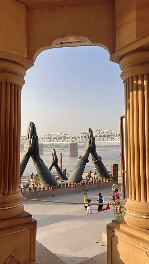 The riverfront framed through the columns of a ghat pavilion